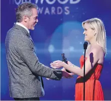  ?? TRIBUNE NEWS SERVICE ?? Director Jean-Marc Vallée, left, accepts the Hollywood Breakthrou­gh Director Award for Wild from Reese Witherspoo­n during the Hollywood Film Awards at The Palladium on Nov. 14, 2014, in Hollywood, California.
