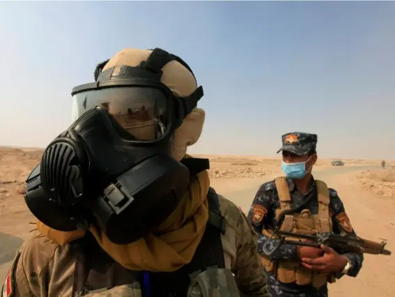  ??  ?? Troops had to wear masks as sulphur fumes enveloped the advance, killing civilians (Reuters)