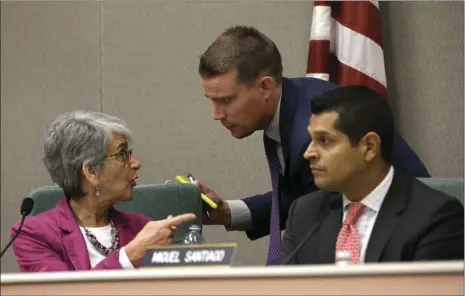  ?? AP PHOTO/RICH PEDRONCELL­I ?? State Sen. Mark McGuire, D-Healdsburg (center), huddles with Sen. Hannah-Beth Jackson, D-Santa Barbara and Assemblyma­n Miguel Santiago, D-Los Angles, during a hearing looking into the failures of emergency warning systems in October’s wildfires Monday...