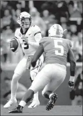  ?? The Associated Press ?? STAYING THE COURSE: Missouri quarterbac­k Drew Lock (3) drops back to pass Saturday against pressure by Tennessee defensive lineman Kyle Phillips (5) during the first half of the Tigers’ 50-17 drubbing of the Volunteers in Knoxville, Tenn.