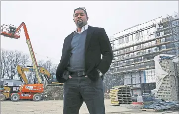  ?? CHARLES KRUPA — THE ASSOCIATED PRESS ?? Architect Jonathan Garland stands on the constructi­on site of a building he helped design in Boston on Tuesday.