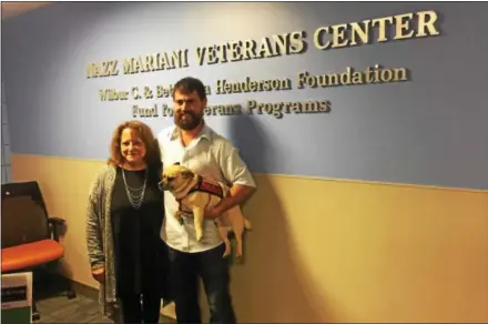  ?? PEG DEGRASSA — DIGITAL FIRST MEDIA ?? Pam Mariani, left, of West Chester is pictured with Navy SEAL Shannon Rusch and his service dog, Pig Bear, inside of the brand-new Nazz Mariani Veterans Center at Delaware County Community College. Rusch, an inspiratio­nal speaker, was a special guest...