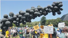  ?? AFP ?? Black balloons are released during a rally of thousands calling for action on climate change in Sydney yesterday.