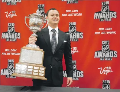  ?? JOHN LOCHER/ THE ASSOCIATED PRESS ?? Jiri Hudler of the Calgary Flames poses with the Lady Byng Memorial Trophy after winning the award Wednesday night in Las Vegas. His coach, Bob Hartley was named bench boss of the year.