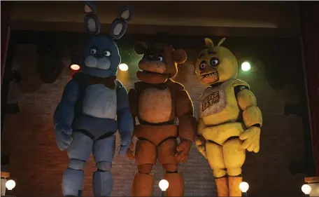  ?? UNIVERSAL PICTURES VIA AP ?? This image released by Universal Pictures shows, from left, Bonnie, Freddy Fazbear and Chica in a scene from “Five Nights at Freddy’s.”