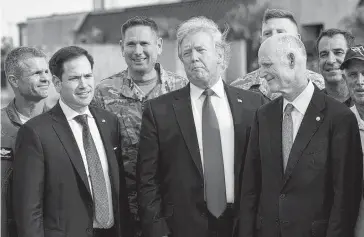 ?? BRENDAN SMIALOWSKI AFP/Getty Images ?? President Donald Trump, with Sens. Rick Scott, right, and Marco Rubio, toured hurricane-damaged Tyndall Air Force Base near Panama City in May. The $17 million project will be put on hold so portions of the U.S.-Mexico border wall can be built.