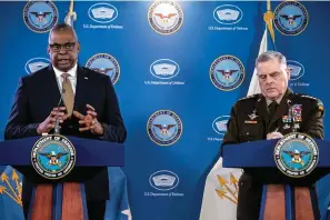  ?? The Associated Press ?? ■ Secretary of Defense Lloyd Austin, left, accompanie­d by Chairman of the Joint Chiefs Gen. Mark Milley, speaks Wednesday during a briefing at the Pentagon in Washington.