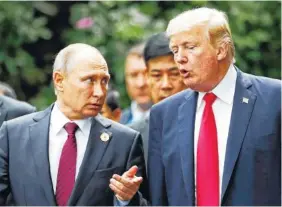  ?? THE ASSOCIATED PRESS ?? U.S. President Donald Trump and Russia’s President Vladimir Putin talk Saturday during the family photo session at the APEC Summit in Da Nang, Vietnam.