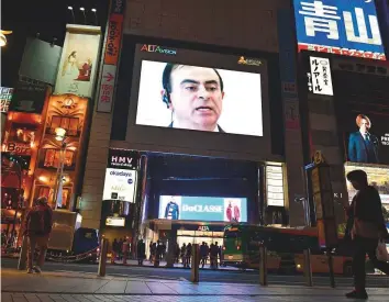  ?? AFP ?? A screen shows a news programme featuring sacked Nissan chairman Carlos Ghosn in Tokyo ■ yesterday after his arrest for financial misconduct.