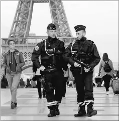 ??  ?? Police patrol at the Trocadero near the Eiffel Tower after a policeman was killed and two others were wounded in a shooting incident. — Reuters photo