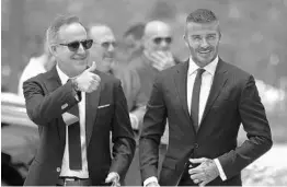  ?? JOE RAEDLE/GETTY IMAGES ?? Jorge Mas, left, and David Beckham arrive at a rally in support of their MLS stadium plan. Beckham has struggled to secure land for the venue, hindering the club’s launch.