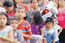  ?? DAVID J. PHILLIP/ASSOCIATED PRESS ?? Immigrant families line up to enter the central bus station after they were processed and released by U.S. Customs and Border Protection in McAllen, Texas, on Sunday.