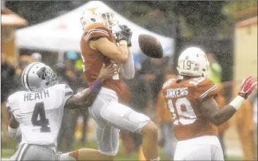  ?? CONTRIBUTE­D BY STEPHEN SPILLMAN ?? Longhorns safety Dylan Haines can’t come up with an intercepti­on Saturday in front of Kansas State’s Dominique Heath. Haines atoned for the mistake with an intercepti­on that helped seal the victory.