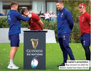  ??  ?? Captain’s presentati­on May receives his 2020 Six Nations medal from Owen Farrell