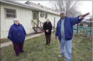  ?? STEVEN M. FALK/THE PHILADELPH­IA INQUIRER VIA AP ?? In a March 27, 2018 photo, Sister Margaret McKenna, left with Sister Sylvia Strahler, and Gary Robinson talk about the New Jerusalem Laura recovery Center Garden on Norris Street in North Philadelph­ia. Hundreds of recovering users such as Robbins have...