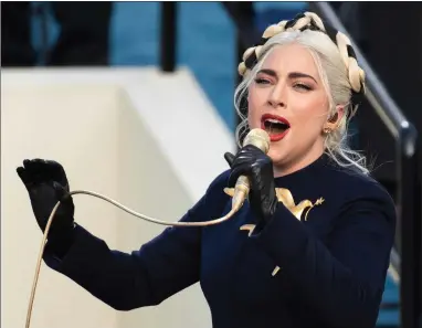  ?? PHOTO BY SAUL LOEB/POOL ?? Lady Gaga sings the national anthem during President-elect Joe Biden’s inaugurati­on at the U.S. Capitol in Washington on Jan. 20. Officials say Lady Gaga’s dog walker was shot and her two French bulldogs stolen in Hollywood during an armed robbery. Los Angeles police are seeking two suspects, though it’s not known if both were armed, in connection with the Wednesday night shooting.