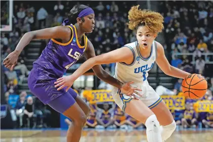  ?? MARY ALTAFFER/ASSOCIATED PRESS FILE PHOTO ?? UCLA guard Kiki Rice drives against LSU guard Flau’jae Johnson on March 30 in the women’s NCAA Tournament in Albany, N.Y. The ratings for the first four rounds of the tournament have skyrockete­d, including a record-breaking 12.3 million who tuned in for the Iowa-LSU game in the Elite Eight on Monday.