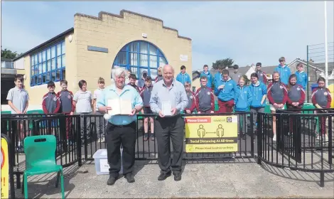  ??  ?? At Bishop O’Brien Memorial National School, Bartlemy on Tuesday, Christy Roche and John Arnold visited to impart their knowledge of Bishop John O’Brien - Christy is holding a rare copy of the Irish-English dictionary penned by Bishop O’Brien.