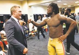  ?? Michael Zagaris / Getty Images 2017 ?? 49ers general manager John Lynch and linebacker Reuben Foster have an animated discussion in the locker room after a win over the Texans at Houston’s NRG Stadium on Dec. 10.