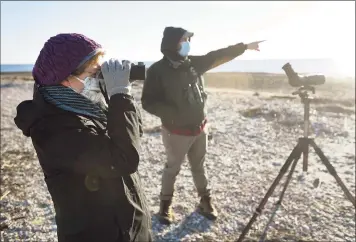  ?? Brian A. Pounds / Hearst Connecticu­t Media ?? Pat Negro, left, of New Haven, observes birds with Audubon habitat steward Stefan Martin during a bird walk at the Audubon Coastal Center on Milford Point on Dec. 3.