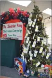  ?? ?? Tags with Christmas wishes from children hang on the wish tree in the Swift Current Salvation Army’s Christmas Room inside the Swift Current Mall. People can help to make these wishes come true by buying the gifts written down on these tags.