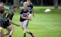  ?? PHOTO: DAVID UNWIN/STUFF ?? Feilding High School’s Drew Wild gets the ball away during his side’s march to the colts sevens title on Saturday.