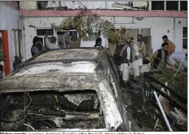  ?? (AP/Khwaja Tawfiq Sediqi) ?? Afghan people examine damage Sunday after the U.S. drone strike in Kabul.