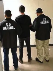  ?? CONTRIBUTE­D BY THE U.S. MARSHALS SERVICE ?? Cody Wilson is escorted by U.S. marshals after his arrest in Taiwan on sexual assault charges. He was brought back to the U.S. and was in the Harris County Jail on Sunday.