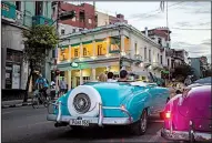  ?? AP/DESMOND BOYLAN ?? In this June photo, tourists ride classic American convertibl­es in Havana where the government will allow new restaurant­s, bed-and-breakfasts and transporta­tion businesses by the end of the year.