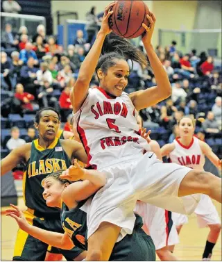  ?? IAN LINDSAY — PNG ?? SFU’S Nayo Raincock-ekunwe grabs a rebound and comes down on top of Alaska’s Kylie Burns Thursday night on Burnaby Mountain.