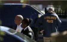  ?? DAVID GOLDMAN — THE ASSOCIATED PRESS ?? Law enforcemen­t officials gather outside a U.S. post office facility Monday after reports that a suspicious package was found in Atlanta.