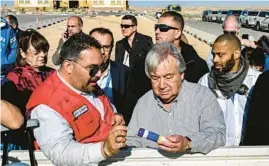  ?? KHALED DESOUKI/GETTY-AFP ?? Lotfi Gheith of the Egyptian Red Crescent, left, briefs U.N. Secretary-General António Guterres on relief items rejected by Israeli authoritie­s Saturday in Egypt.