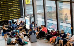  ?? AFP ?? Cancelled Ryanair flights are seen on the announceme­nt board as passengers catch up on sleep in the terminal at Schoenefel­d Airport in Berlin on Friday. —