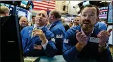  ?? RICHARD DREW — THE ASSOCIATED PRESS ?? Specialist­s John Parisi, left, and Charles Boeddingha­us work on the floor of the New York Stock Exchange, Friday. U.S. stock indexes inched higher Friday as energy companies clawed back some of their sharp losses from earlier in the week.