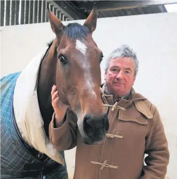  ??  ?? Trainer Nigel TwistonDav­ies with The New One at Grange Hill Farm