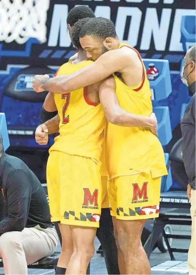  ?? MARK HUMPHREY/AP ?? Maryland’s Aaron Wiggins (2) hugs Galin Smith during the final seconds of the Terps’ loss to Alabama in the second round of the NCAA tournament at Bankers Life Fieldhouse in Indianapol­is on Monday night. Alabama won 96-77.
