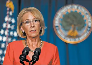  ?? MANUEL BALCE CENETA/AP ?? U.S. Education Secretary Betsy DeVos says kids can safely go to school. Health experts say there are many uncertaint­ies.