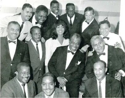  ?? PHOTO BY BERT JAYE, COURTESY OF NORMAN MARSHALL VILLENEUVE ?? The Rockhead’s Paradise house band with Louis Armstrong and His All-Stars in 1964, backstage at the Montreal Forum, where Armstrong was playing. Villeneuve is at the far left of the back row. Allan Wellman, trumpeter and leader of the Rockhead’s band, is second from left in the middle row. Rockhead’s pianist Linton Garner is at the far left of the bottom row. Rockhead’s bassist Nick Aldrich is at the far right of the bottom row.