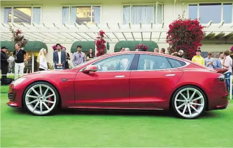  ??  ?? Exclusive look A Tesla Motors Model S automobile is displayed during the 2014 Pebble Beach Concours d’Elegance in Pebble Beach, California lastmonth. it’s no coincidenc­e that the first US customers received their keys to the i8 at an event tied to the...