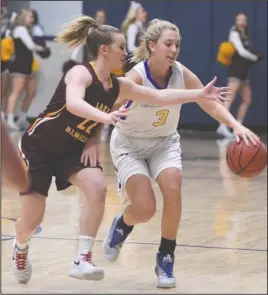  ?? The Sentinel-Record/Mara Kuhn ?? POWERING TO THE HOOP: Lakeside’s Thea Rice drives the ball as Lake Hamilton’s Morgan Fincham defends during the basketball game at Lakeside Athletic Complex on Friday. The Lady Rams took a 41-40 win over the Lady Wolves.