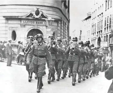  ??  ?? Nazis march through Guernsey in 1940. Christine has found a fantastic resource for anyone with Channel Island ancestors