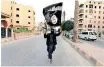  ?? ?? A MEMBER loyal to the Islamic State in Iraq and the Levant waves their flag in Raqqa in 2014. | REUTERS