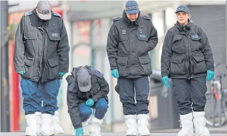  ?? Picture: Shuttersto­ck. ?? Police forensics officers continue their search of the crime scene yesterday.