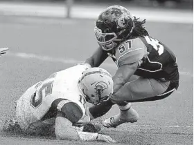  ?? KIM HAIRSTON/BALTIMORE SUN PHOTO ?? Morgan State linebacker Cody Acker, right, sacks Tyler Clark in the Bears’ loss to Norfolk State on Sept. 28. Acker leads the Bears defense in solo tackles and overall stops.