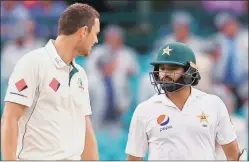  ?? Reuters ?? Azhar Ali (R) and Josh Hazlewood exchange words as they walk off the ground at the end of the day’s play.