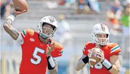  ?? AL DIAZ/AP ?? Miami quarterbac­ks N’Kosi Perry, left, and Tate Martell are vying for the Hurricanes’ starting job, along with fellow signal caller Jarren Williams.