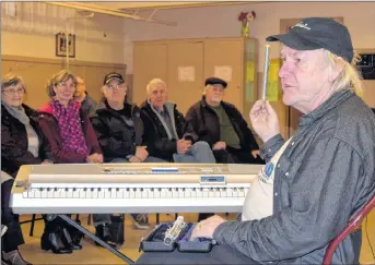  ?? SAM MACDONALD/THE NEWS ?? Instructor Paul Barrett demonstrat­es the flute to prospectiv­e members of the New Horizons Band program, at Christ Anglican Church in Stellarton.