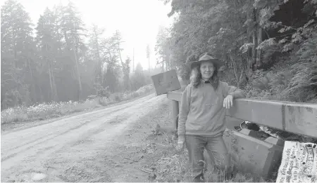  ??  ?? Flyfisher Kym Hill at a gate along the road to the Leech water supply area.