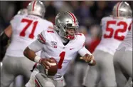  ?? CHARLES REX ARBOGAST - THE ASSOCIATED PRESS ?? Ohio State quarterbac­k Justin Fields (1) scrambles during the first half of an NCAA college football game against Northweste­rn, Friday, Oct. 18, 2019, in Evanston, Ill.