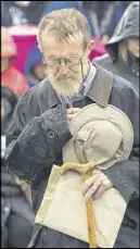  ?? ANDREW VAUGHAN - THE CANADIAN PRESS ?? Halifax firefighte­rs lay a wreath at a ceremony to mark the 100th anniversar­y of the Halifax Explosion at Fort Needham Memorial Park in Halifax on Wednesday. At right, John Scidmore from St. Thomas, Ont. takes pause during the closing prayer.